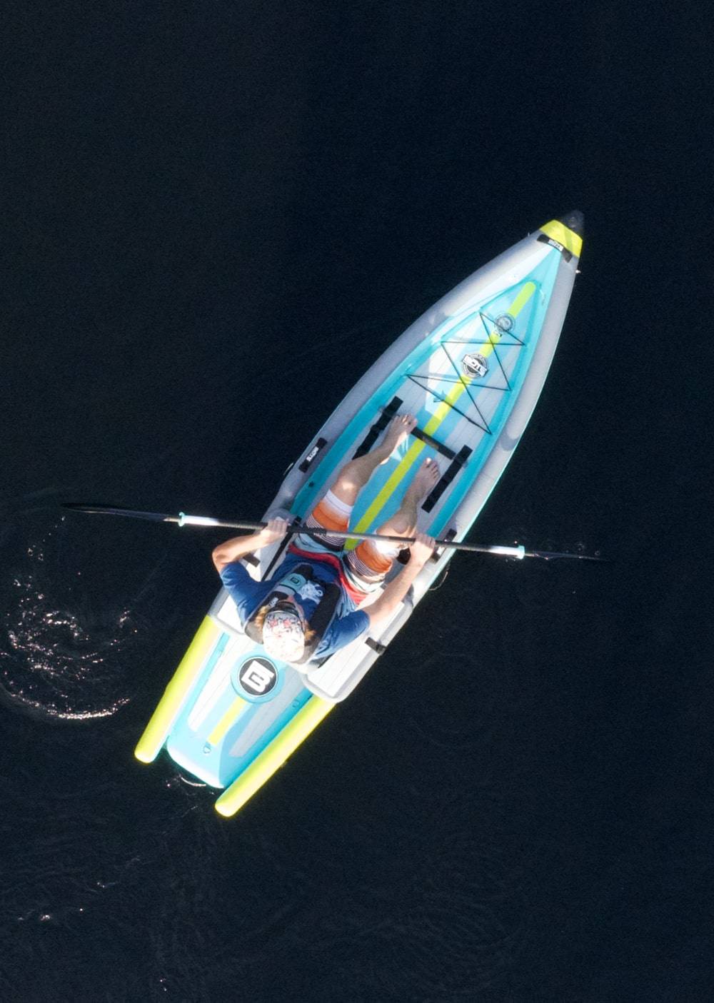 Overhead view of a man paddling the DEUS Aero Native Citron